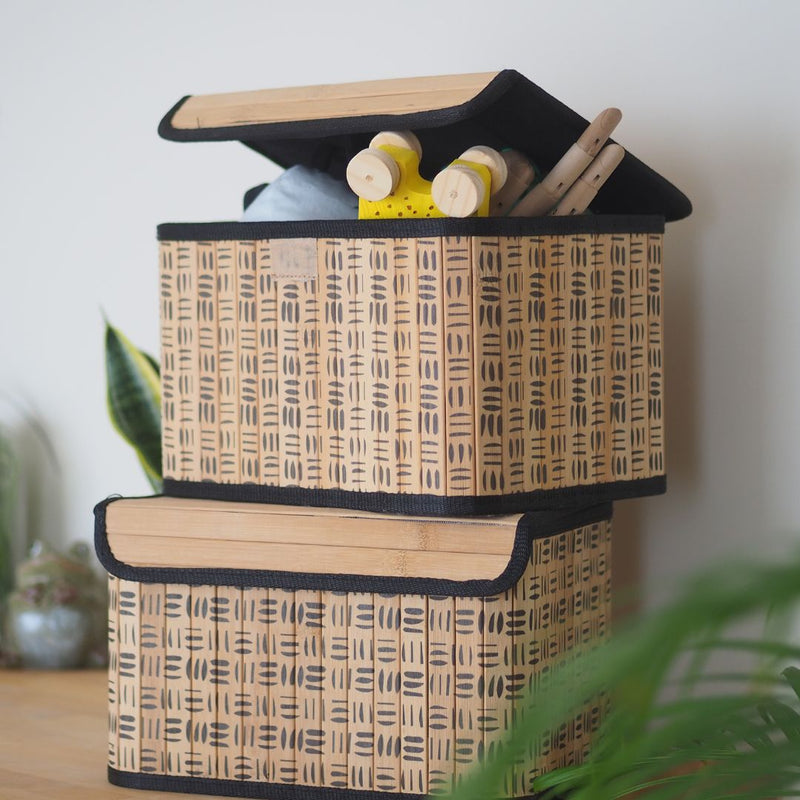 Two woven storage baskets with geometric patterns on a light background